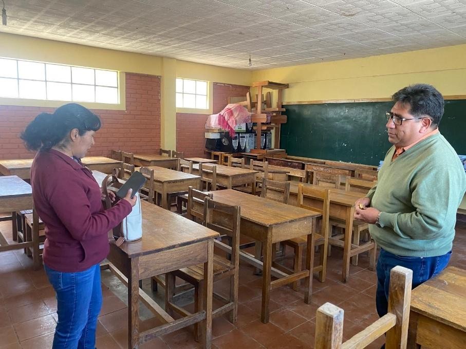  De directeur en een medewerker in het lege klaslokaal. Het klaslokaal dat wordt omgebouwd tot minibibliotheek